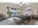 Bright main bedroom features a ceiling fan, outside access, and a stylish neutral color palette at 21798 N Ingram Ct, Maricopa, AZ 85138