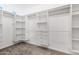 Spacious walk-in closet with custom built-in shelving and drawers, providing ample storage solutions at 21798 N Ingram Ct, Maricopa, AZ 85138