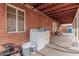 Covered back porch with a brick wall, washer and dryer, and outdoor furniture at 2230 N 14Th Pl, Phoenix, AZ 85006