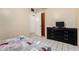 A tidy bedroom with tiled floors, a black dresser, and bright walls at 2230 N 14Th Pl, Phoenix, AZ 85006