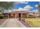 A charming single-story brick home featuring a well-maintained front yard and covered porch at 2230 N 14Th Pl, Phoenix, AZ 85006