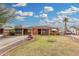 Charming brick home with a well-manicured lawn, mature palm tree, and a welcoming front porch at 2230 N 14Th Pl, Phoenix, AZ 85006