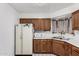 Kitchen featuring wood cabinets, white appliances, and a window for natural light at 2230 N 14Th Pl, Phoenix, AZ 85006