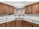 Cozy kitchen with wood cabinets, white countertops, and window above the sink at 2230 N 14Th Pl, Phoenix, AZ 85006