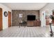 Bright living room featuring a decorative stone wall, neutral tile flooring, and modern media console at 2230 N 14Th Pl, Phoenix, AZ 85006