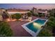 Aerial view of a backyard with a pool and landscaped seating area at 23236 N Caleta Ct, Sun City West, AZ 85375