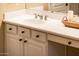 Bathroom vanity featuring a white countertop, undermount sink, and black hardware at 23236 N Caleta Ct, Sun City West, AZ 85375