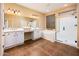 This bright bathroom offers a glass shower, soaking tub, and double vanity at 23236 N Caleta Ct, Sun City West, AZ 85375