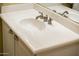 Bathroom vanity featuring a white countertop, undermount sink, and stainless hardware at 23236 N Caleta Ct, Sun City West, AZ 85375