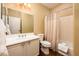 Bathroom with a white vanity, large mirror, toilet and shower/tub combination at 23236 N Caleta Ct, Sun City West, AZ 85375