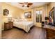 Bedroom with wood-look tile flooring, ceiling fan, and a cozy window at 23236 N Caleta Ct, Sun City West, AZ 85375