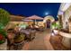 Beautiful courtyard featuring a fountain, desert landscaping, a fire pit and outdoor seating at 23236 N Caleta Ct, Sun City West, AZ 85375