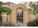 Inviting courtyard entrance with archway, lighting, and comfortable seating at 23236 N Caleta Ct, Sun City West, AZ 85375