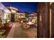 Exterior of a charming courtyard with comfortable seating, desert plants and exterior lighting at 23236 N Caleta Ct, Sun City West, AZ 85375