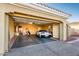 Spacious garage with a sports car, storage, and ample parking at 23236 N Caleta Ct, Sun City West, AZ 85375