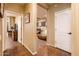 View of the entry hallway leading into the living room and office space, showcasing the flooring and natural lighting at 23236 N Caleta Ct, Sun City West, AZ 85375