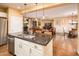 The open-concept kitchen flows seamlessly into living room and has stainless appliances at 23236 N Caleta Ct, Sun City West, AZ 85375