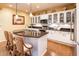 This kitchen features granite counters, pendant lighting, and white cabinets with glass displays at 23236 N Caleta Ct, Sun City West, AZ 85375