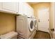 Laundry room with modern washer and dryer, and storage cabinets at 23236 N Caleta Ct, Sun City West, AZ 85375