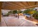 Spacious patio area with a pergola, outdoor seating, a cozy fireplace, and a view of the refreshing swimming pool at 23236 N Caleta Ct, Sun City West, AZ 85375