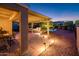 Covered outdoor patio offering a dining area and access to the pool, surrounded by low maintenance desert landscaping at 23236 N Caleta Ct, Sun City West, AZ 85375