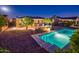 Backyard view of a refreshing pool, stone patio and desert landscaping at 23236 N Caleta Ct, Sun City West, AZ 85375