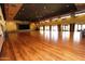 Large ballroom showcasing gleaming hardwood floors, elegant chandeliers, and ample space for events at 26405 S Lakewood Dr, Sun Lakes, AZ 85248