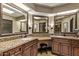 Spacious bathroom with dual granite countertops and decorative mirrors to accentuate the space at 26405 S Lakewood Dr, Sun Lakes, AZ 85248