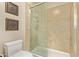 Bathroom featuring tile floors, glass shower doors and modern fixtures at 26405 S Lakewood Dr, Sun Lakes, AZ 85248