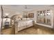 Comfortable bedroom featuring a decorative bed frame, ceiling fan and plantation shutters at 26405 S Lakewood Dr, Sun Lakes, AZ 85248