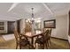 Formal dining room with tile flooring, statement lighting, neutral paint colors, and elegant wood furnishings at 26405 S Lakewood Dr, Sun Lakes, AZ 85248