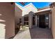 Covered front entry with brick pavers, a decorative fountain, and an iron trimmed glass front door at 26405 S Lakewood Dr, Sun Lakes, AZ 85248