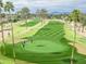 Aerial shot of the manicured community golf course with golfers enjoying a round of golf at 26405 S Lakewood Dr, Sun Lakes, AZ 85248