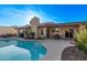 Backyard view of a private in-ground pool with covered patio, blue skies, and desert landscaping at 26405 S Lakewood Dr, Sun Lakes, AZ 85248