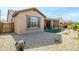 Low-maintenance backyard with gravel, artificial turf, and drought-resistant plants at 26578 W Piute Ave, Buckeye, AZ 85396