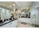 Spacious bathroom featuring dual sinks, black countertops, and a large glass-enclosed shower at 26578 W Piute Ave, Buckeye, AZ 85396