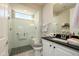 Modern bathroom with a glass shower, granite countertop, and a window for natural light at 26578 W Piute Ave, Buckeye, AZ 85396