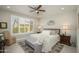 Inviting bedroom with neutral tones, plantation shutters, and stylish decor at 26578 W Piute Ave, Buckeye, AZ 85396