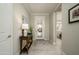 Bright foyer features a decorative front door, neutral walls, and a decorative table at 26578 W Piute Ave, Buckeye, AZ 85396