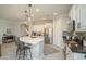 Bright kitchen featuring stainless steel appliances, white cabinetry, and a stylish island with seating at 26578 W Piute Ave, Buckeye, AZ 85396