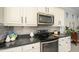 Close-up of the kitchen showcasing the modern appliances and elegant backsplash at 26578 W Piute Ave, Buckeye, AZ 85396