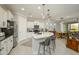 Modern kitchen featuring a large island with bar seating, white cabinets, and stainless steel appliances at 26578 W Piute Ave, Buckeye, AZ 85396