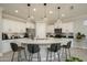 Modern kitchen featuring a large island with bar seating, white cabinets, and stainless steel appliances at 26578 W Piute Ave, Buckeye, AZ 85396