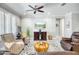 Stylish living room with a modern ceiling fan, elegant decor, and an entertainment center, creating a cozy atmosphere at 26578 W Piute Ave, Buckeye, AZ 85396