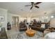 Open-concept living room features a seamless flow into a modern kitchen and stylish furnishings at 26578 W Piute Ave, Buckeye, AZ 85396