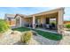 Inviting covered patio with stylish furniture, providing a perfect outdoor relaxation and dining space at 26578 W Piute Ave, Buckeye, AZ 85396