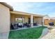 Spacious covered patio with a heater, seating area, and dining table, perfect for outdoor entertaining at 26578 W Piute Ave, Buckeye, AZ 85396