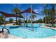 Resort-style pool with ample lounge seating, palm trees and shade canopies at 26578 W Piute Ave, Buckeye, AZ 85396