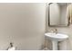 A compact powder room featuring pedestal sink, framed mirror, and neutral wall color at 29304 N Horton Creek Trl, Rio Verde, AZ 85263