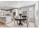 Dining area showcasing a modern chandelier, round table, and seamless flow into the kitchen at 29304 N Horton Creek Trl, Rio Verde, AZ 85263